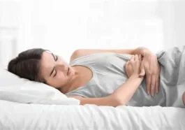 woman lying with hands on tummy because of pain glp 1 gastric emptying Volanesorsen (Waylivra) for Hypertriglyceridemia-Induced Acute Pancreatitis