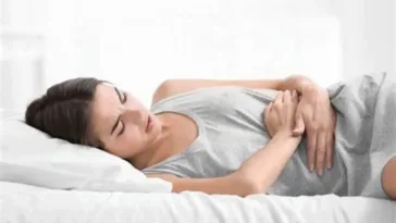 woman lying with hands on tummy because of pain glp 1 gastric emptying Volanesorsen (Waylivra) for Hypertriglyceridemia-Induced Acute Pancreatitis
