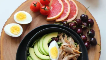 keto vs dopamine diet eggs, fruits, and avocado on a table keto diet vs intermittent fasting keto diet for depression and bipolar disorder