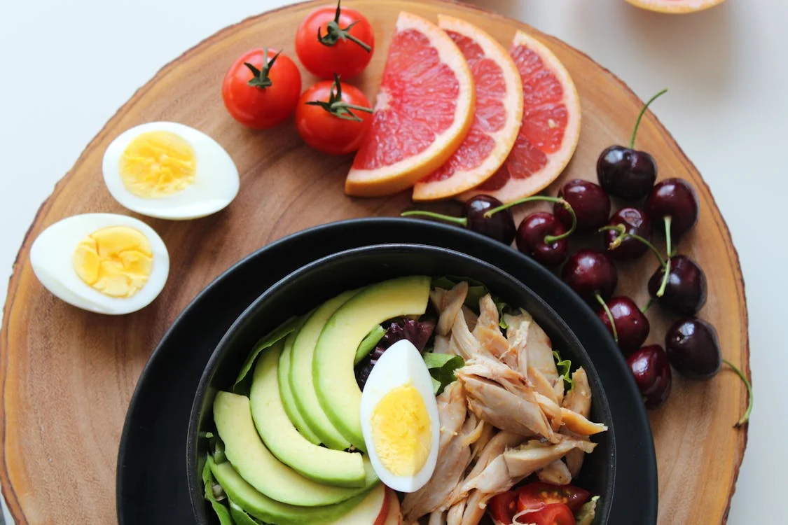 keto vs dopamine diet eggs, fruits, and avocado on a table keto diet vs intermittent fasting keto diet for depression and bipolar disorder